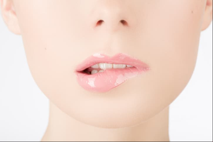 Beauty face closeup. Sexy lips. Beauty pink lips makeup detail. Beautiful make-up close-up. Sensual open mouth. Lipstick and lipgloss