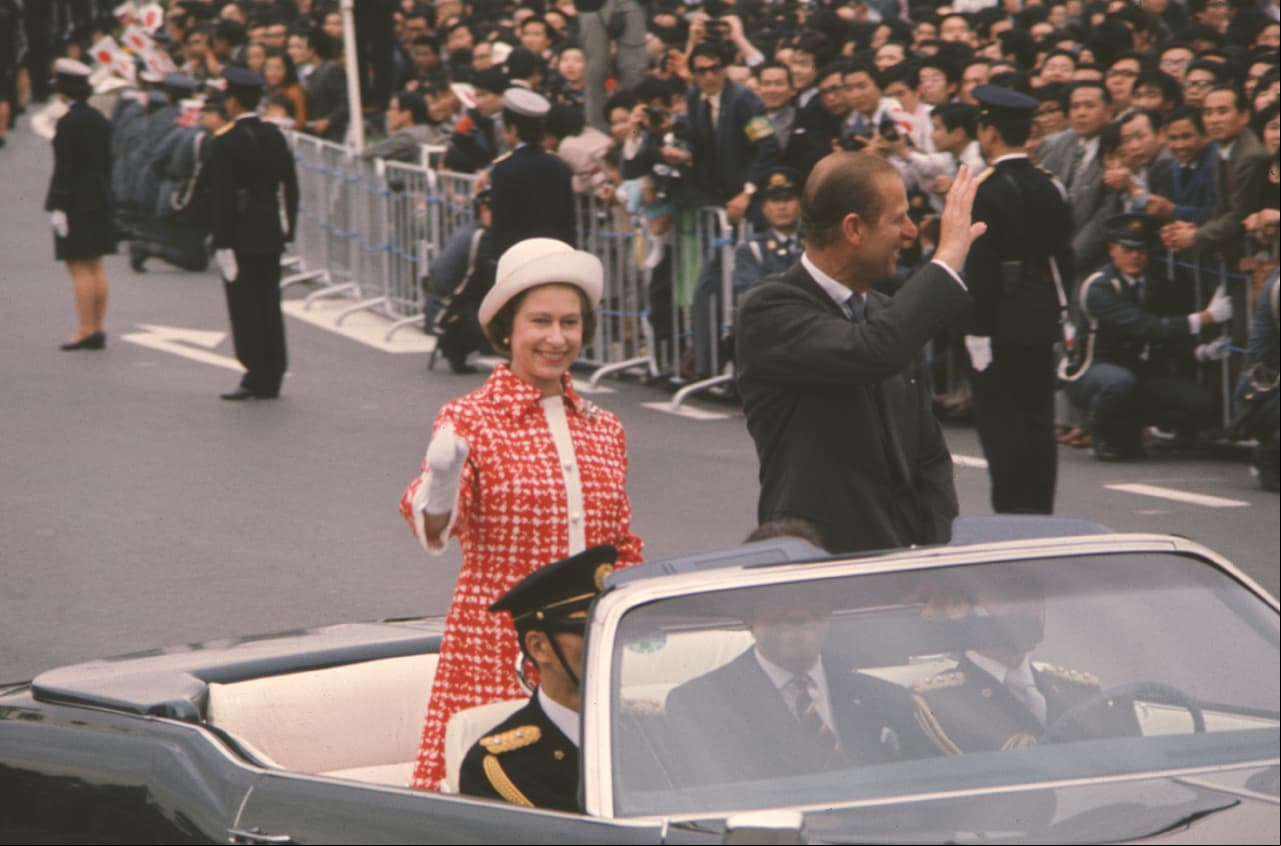 En 1975, la reina Isabel II, en compañía del príncipe Felipe, duque de Edimburgo, saludó a las personas que se dieron cita en Tokio, Japón, durante una caravana. Usó un conjunto rojo y blanco y un sombrero del mismo tono que resaltó drásticamente, a diferencia de los colores negros y grises que la mayoría de los espectadores usaron aquel día.