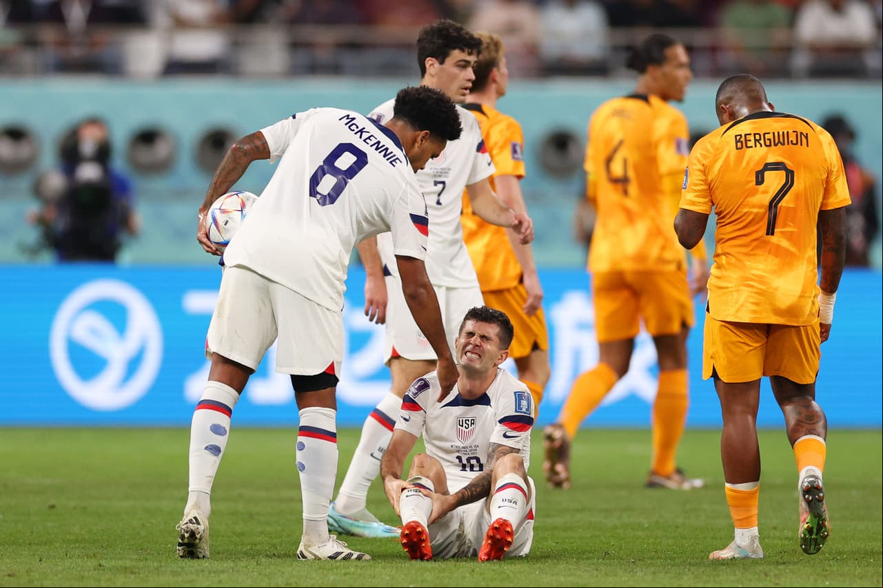 DOHA, QATAR - DECEMBER 03: Christian Pulisic of United States goes down with an injury during the FIFA World Cup Qatar 2022 Round of 16 match between Netherlands and USA at Khalifa International Stadium on December 03, 2022 in Doha, Qatar. (Photo by Elsa/Getty Images)