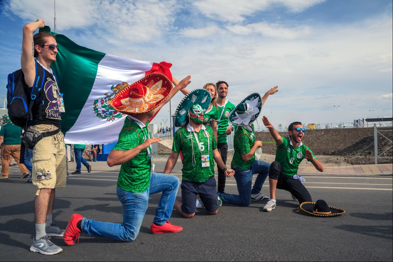 ROSTOV-ON-DON, RUSSIA - 07/17/2018:Mexican fans in suits and sambreros are photographed with the national flag